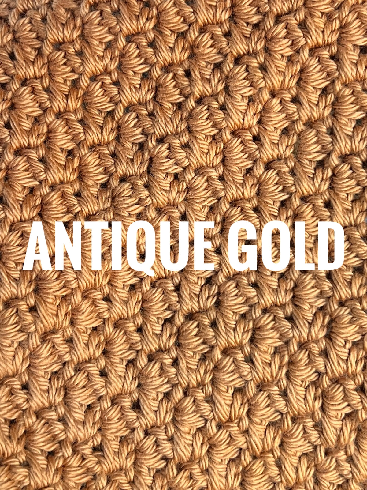 A close-up of a textured crochet washcloth swatch in a warm antique gold color, with the words 'ANTIQUE GOLD' overlaid in large white text across the center.