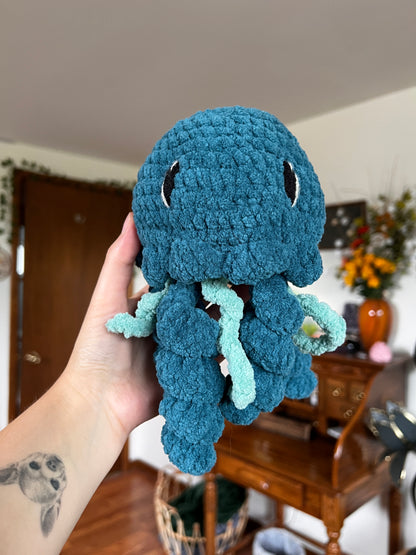 Crochet jellyfish in a turquoise and blue color with embroidered eyes
