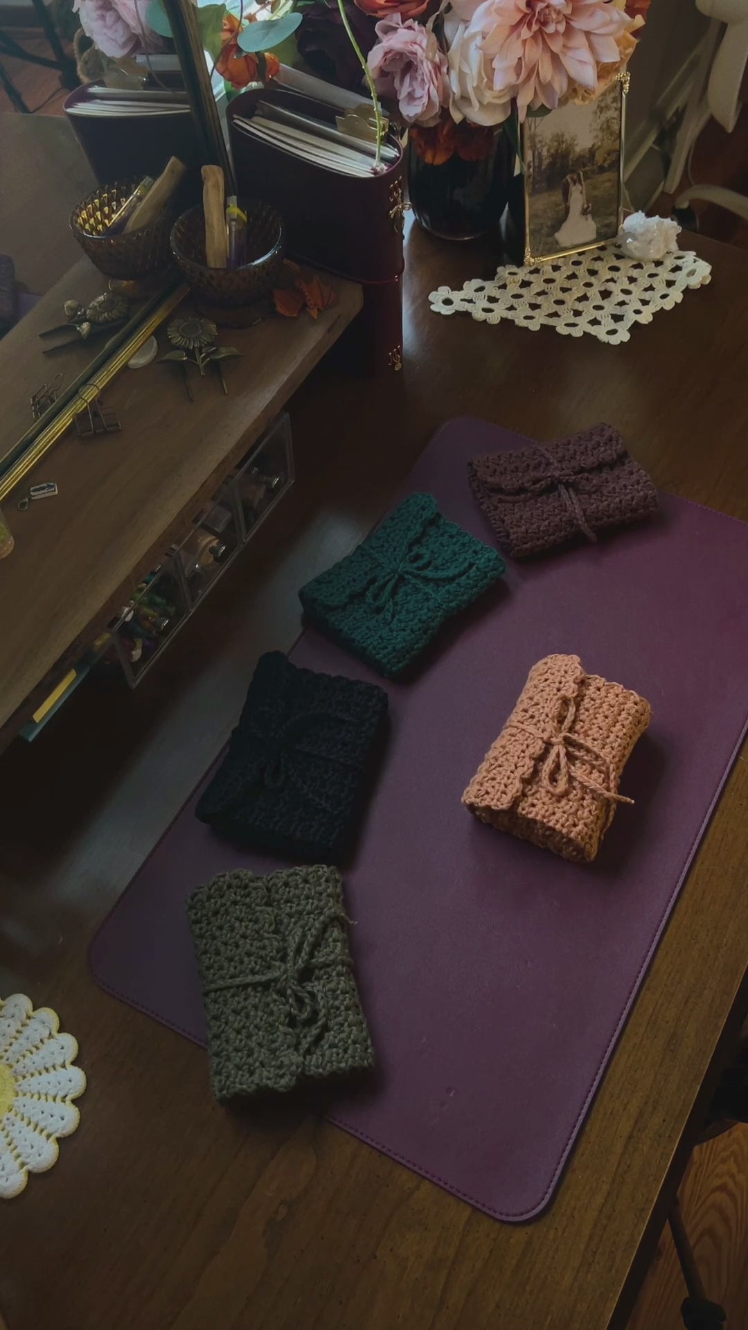 Crochet Tarot Card Roll-Up cases on a desk with purple mat and decor